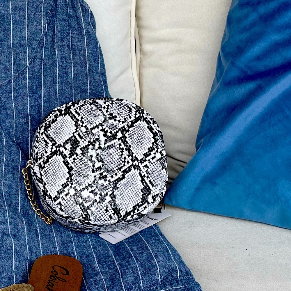 Small round snakeskin bag for anytime fun! Fits all the girl essentials!